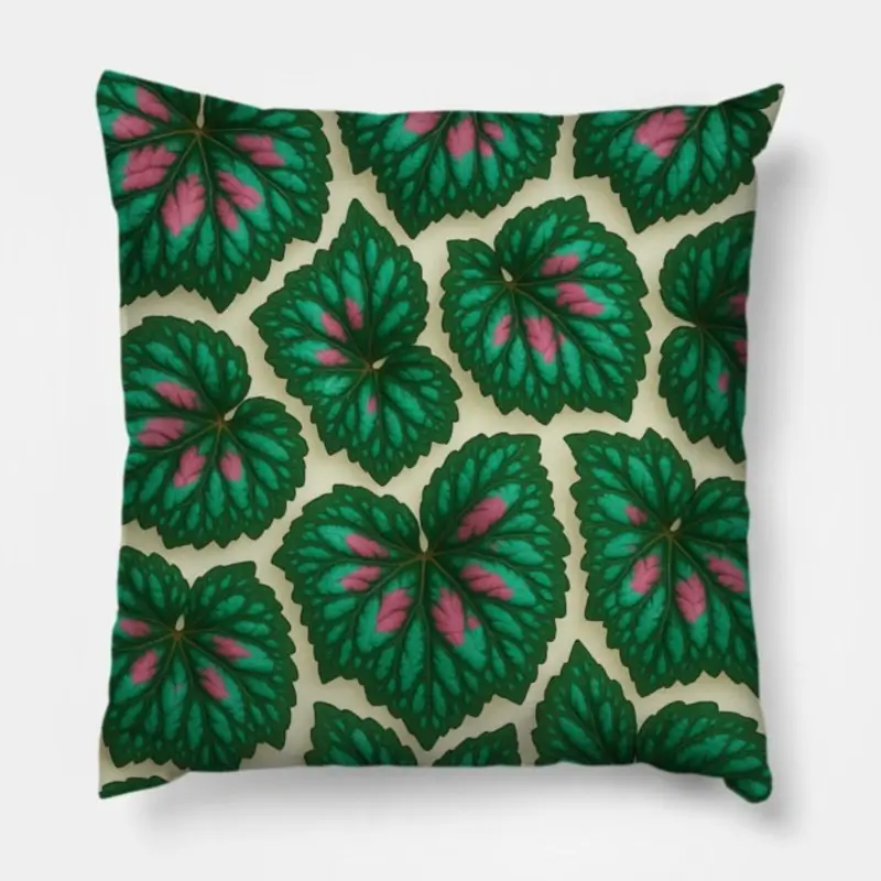 Floral throw pillow featuring Begonia Rex leaf design in green, pink, and turquoise tones