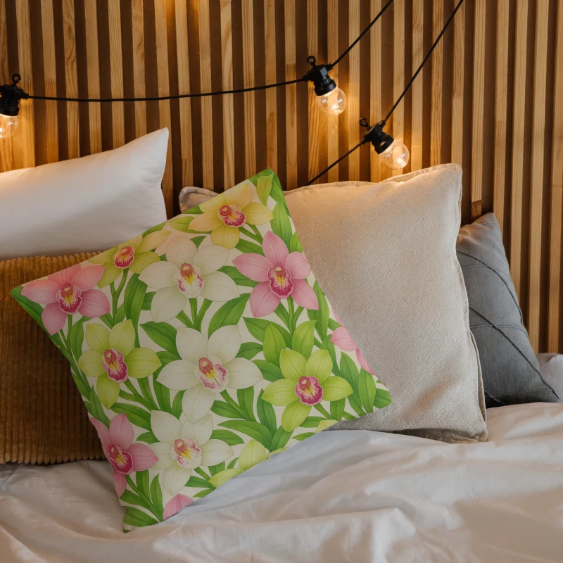 Decorative cymbidium orchid floral throw pillow on a cozy layered bed