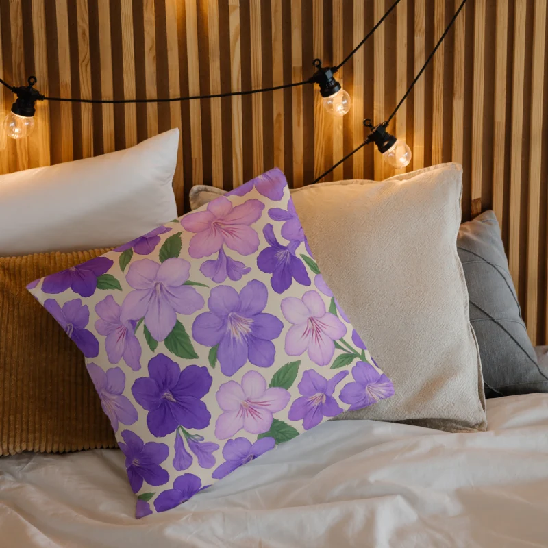 Streptocarpus Cape Primrose floral throw pillow placed on a cozy bed with neutral linens