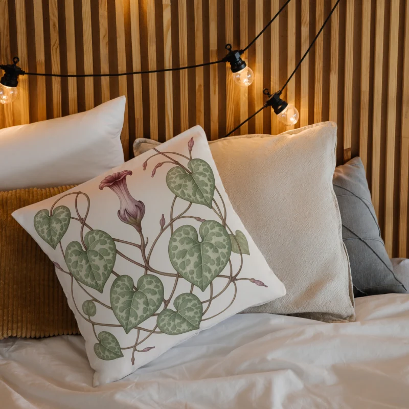 String of Hearts floral throw pillow layered on a cozy bed for elegant bedroom styling