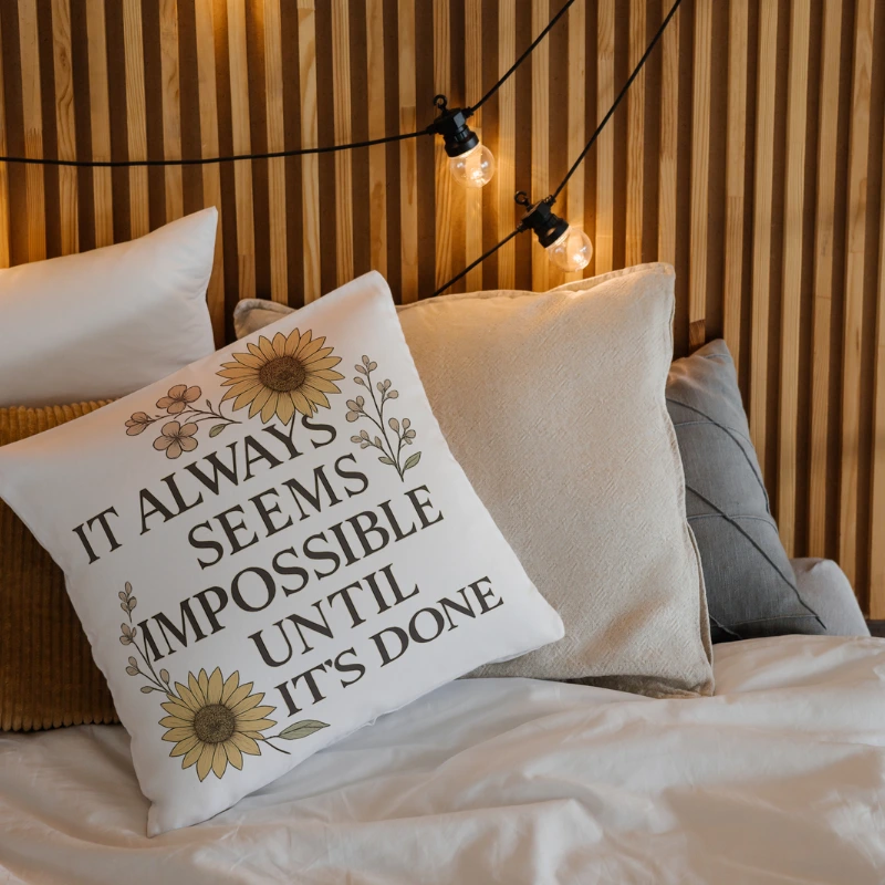 Motivational quote throw pillow on a minimalist bed for daily inspiration