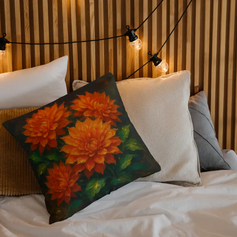 Orange dahlia impasto throw pillow on light bed, glowing petals with warm gold and emerald foliage