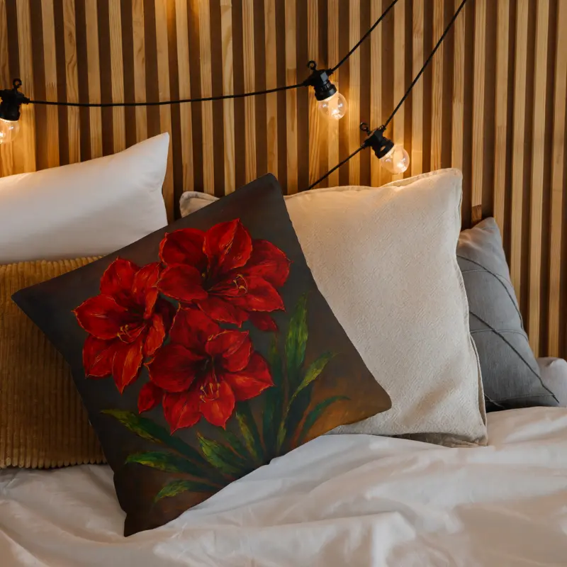 Decorative red amaryllis impasto throw pillow with green stems on neutral bedding