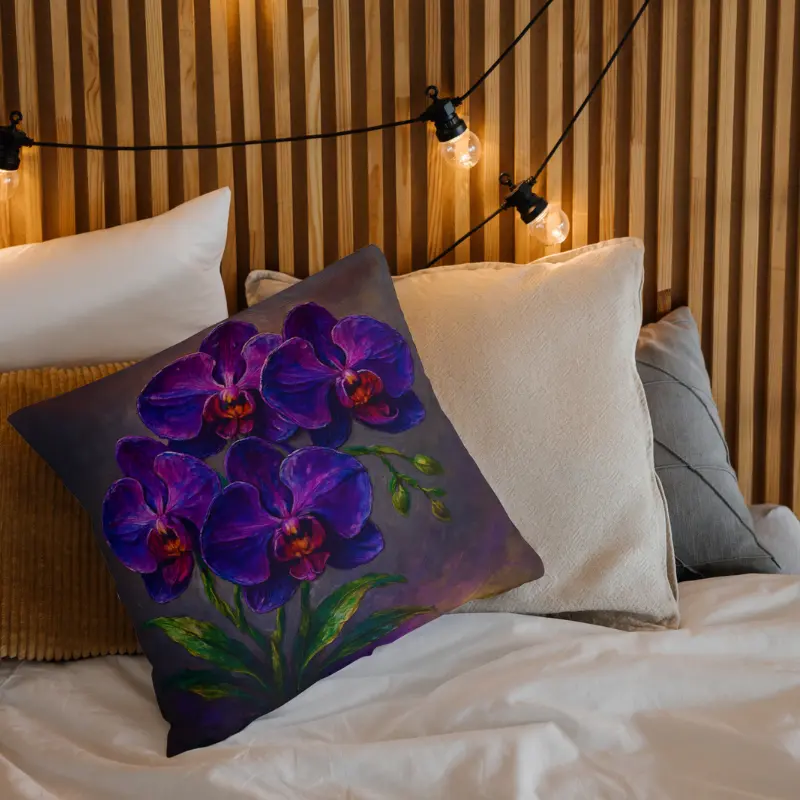 Purple orchid floral impasto pillow styled on light bedding with green leaves and charcoal accents