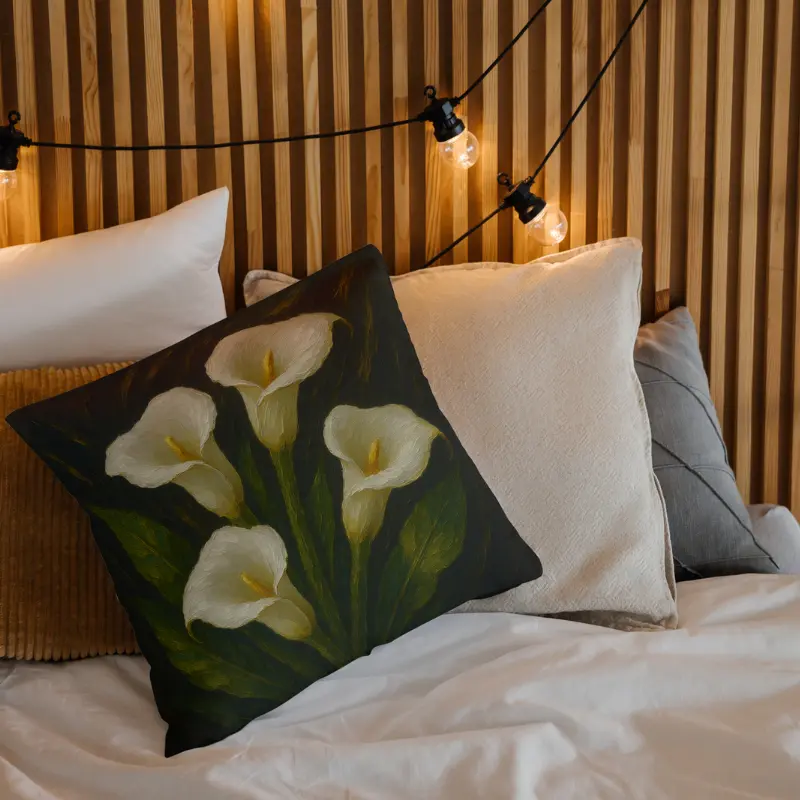 White calla lily impasto throw pillow on light bedding with emerald leaves and soft charcoal gradients